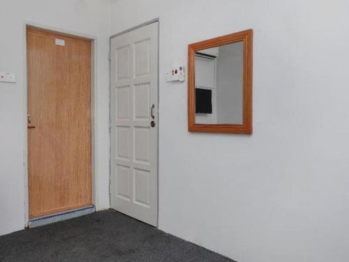 an empty room with a door and a mirror at OYO 90120 MI Hotel Dungun in Dungun