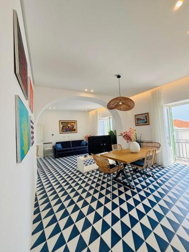a living room with a blue and white checkered floor at Marina Palace Apartments & Terrace in Lipari