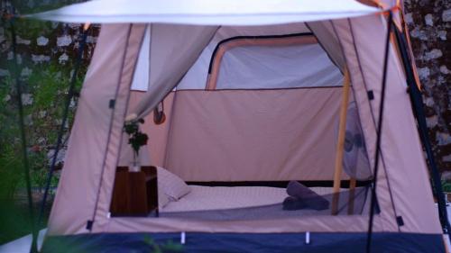 a small tent with a bed in it at Phố Thường Garden in Da Lat