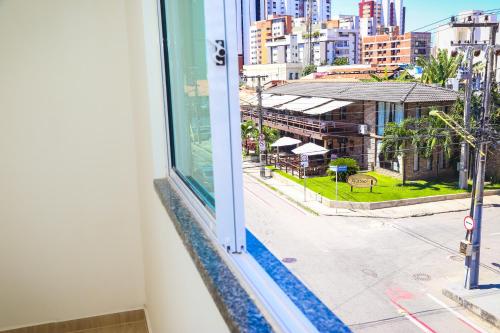 a window with a view of a city street at Pousada Meireles in Fortaleza
