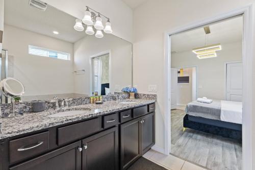 a bathroom with a sink and a large mirror at 3787 Elegant 6BD Island Getaway Windsor Resort in Davenport