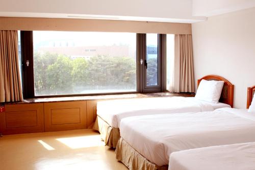Postel nebo postele na pokoji v ubytování The K Hotel Gyeongju