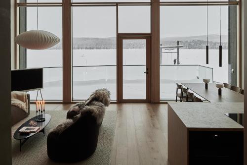 a dog laying on a couch in a living room at Stay North - The House of Northern Lights in Äkäslompolo