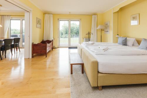 a large bedroom with two beds and a dining room at HEIMATEL - Ferienhaus Blümele in Scheidegg