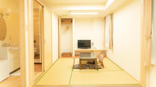 a living room with a floor mat in the middle of a room at Smile Hotel Nishiakashi in Kobe