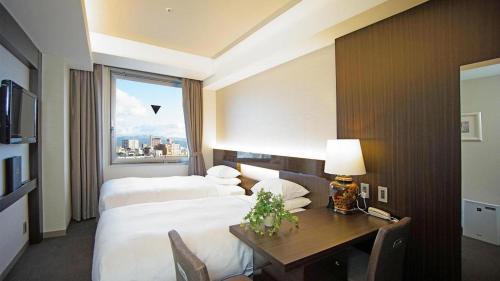 Hotel Riverge Akebonoにあるベッド