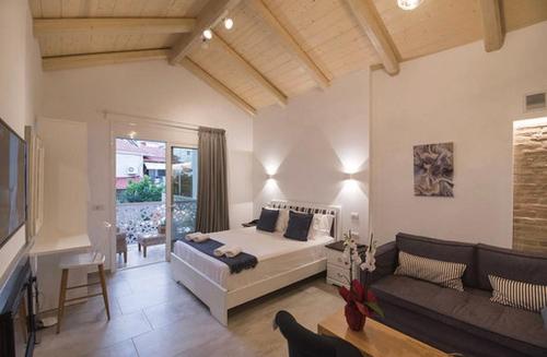 a living room with a bed and a couch at Carezza Apartments in Preveza