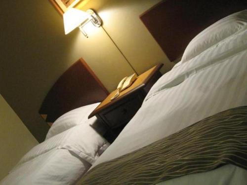 Katil atau katil-katil dalam bilik di Casuarina Hotel