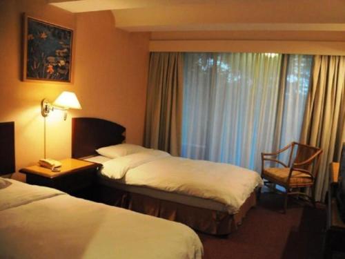 Katil atau katil-katil dalam bilik di Casuarina Hotel