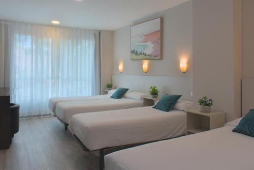 Postel nebo postele na pokoji v ubytování Dormavalencia Hostel Regne