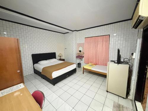 Кровать или кровати в номере Sumber Ria Hotel
