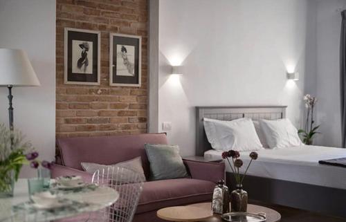 a living room with a bed and a couch at Carezza Apartments in Preveza
