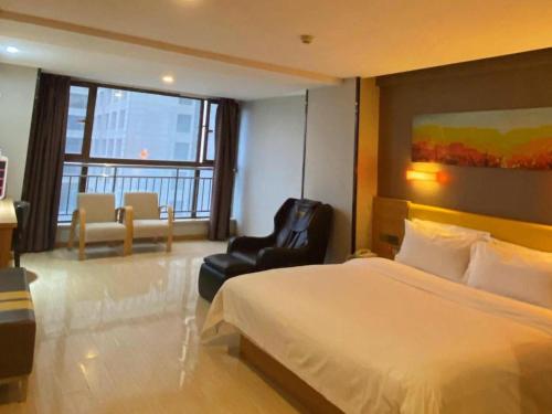 a hotel room with a bed and a chair at 7 Days Premium Xi'an Dayan Tower Xiaozhai Metro Station in Xi'an