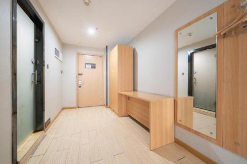 a hallway with a dressing room and a mirror at 7 Days Premium Xi'an Dayan Tower Xiaozhai Metro Station in Xi'an