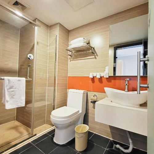 a bathroom with a toilet and a sink and a shower at 7 Days Premium Xi'an Dayan Tower Xiaozhai Metro Station in Xi'an