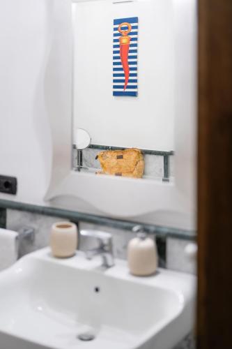 a bathroom with a white sink and a mirror at Luna Guest House - Italian Escape in Vico Equense