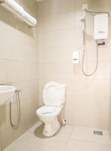 a bathroom with a toilet and a sink at Country Inn in Johor Bahru