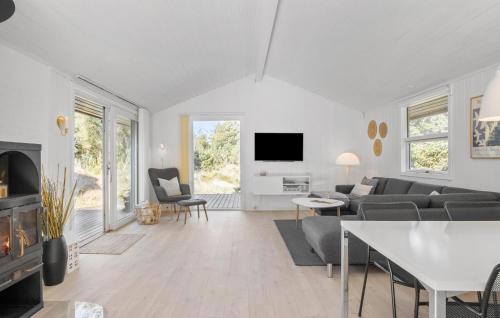 a living room with a couch and a tv at Stunning Home In Saltum With Wifi in Saltum