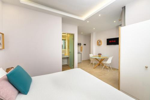 a bedroom with a bed and a dining room at KORINA APART HOTEL KAVOS in Kavos