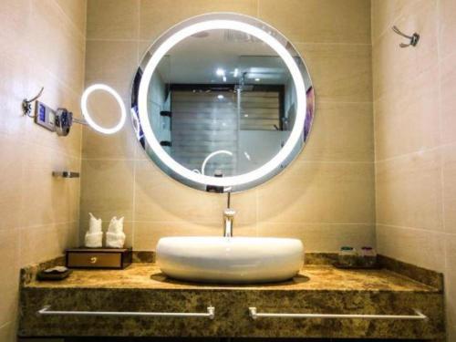 a bathroom with a sink with a large mirror at Lavande Hotel Xi'an Longshouyuan Wenjing Road in Xi'an