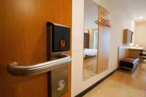 a close up of a door in a room at 7 Days Premium Yancheng Dafeng Zhongjiao Meilu City in Yancheng