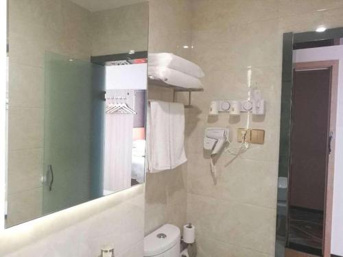 a bathroom with a mirror and a sink and a toilet at 7 Days Premium Yancheng Dafeng Zhongjiao Meilu City in Yancheng