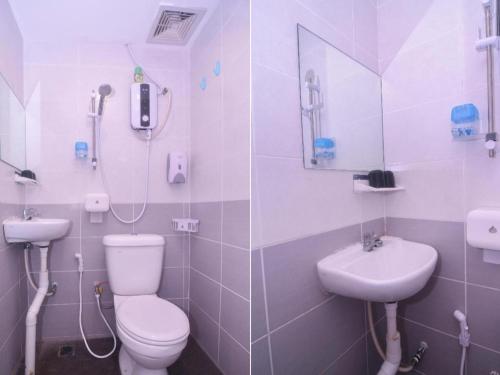 a bathroom with a toilet and a sink at OYO 89465 Golden Lounge in Kuching