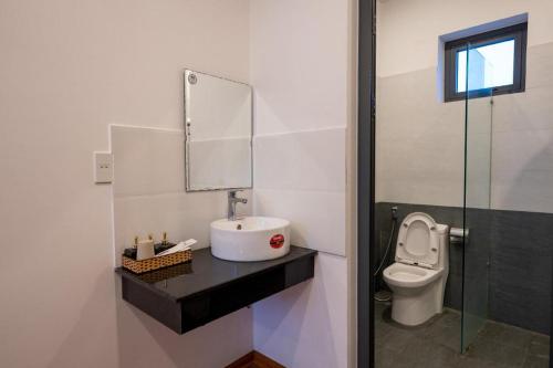 a bathroom with a sink and a toilet at Hoi An Paradise Villa in Hoi An