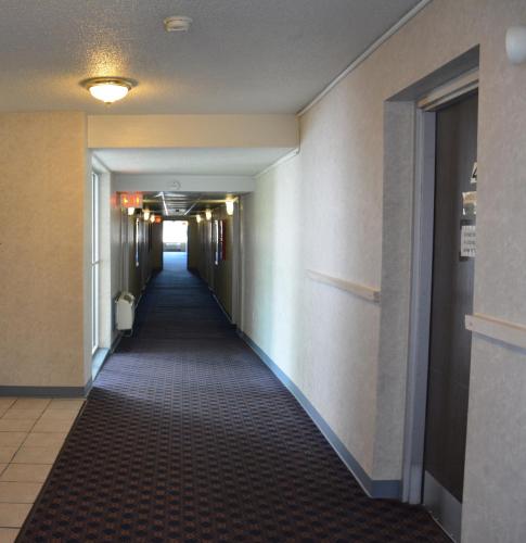 a hallway of a hotel with a long corridor at Travelodge by Wyndham Milwaukee in Milwaukee