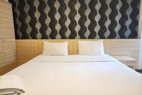 a white bed with two pillows in a room at Station 203 Hotel in Bangkok