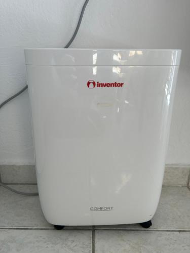 a white computer is sitting on a floor at Οικία αποζαρι μικρή περσα in Kastoria