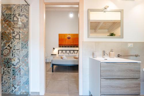 a bathroom with a sink and a mirror at Villa Campidanese in Assemini