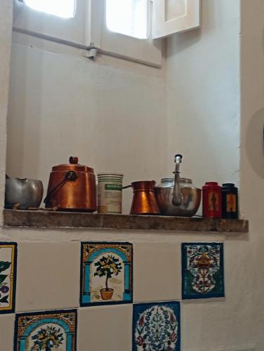 a kitchen shelf with pots and pans on it at Casa del Falco in Vitorchiano