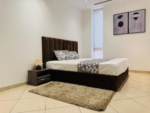 a bedroom with a bed with a headboard and a rug at Villaggio Vista Furnished 3 bedroom room 1st Floor flat & Service room in Accra