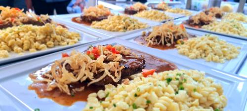 a buffet of different types of food on plates at Hotel Krone in Königsbrunn