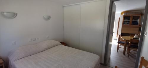une petite chambre avec un lit et une table dans l'établissement Appartement neuf pour non fumeur, très agréable, confort, détente, à Servian