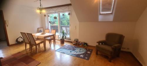 a living room with a dining room table and chairs at Pension Kaden in Dresden