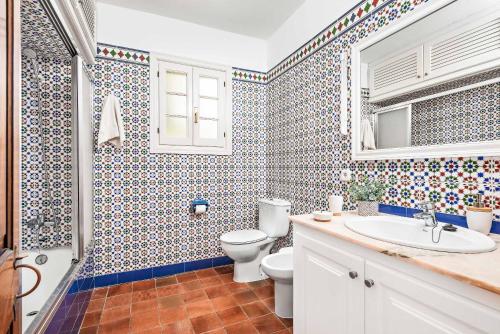 a bathroom with a toilet and a sink at Casa Maria in Cala Galdana