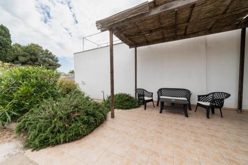 two chairs and a table on a patio at CASA PAPADIA in Uggiano la Chiesa
