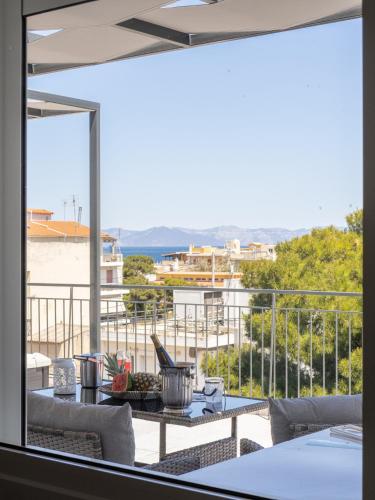 a view of a balcony with a table and chairs at JACUZZI penthouse - King's view in Artemida