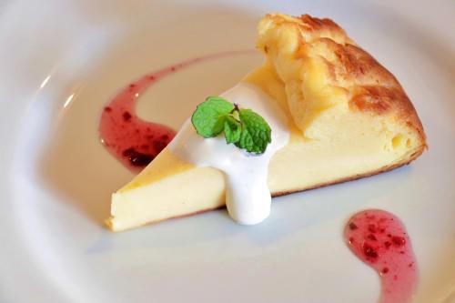 a piece of cheesecake on a white plate at Pension Asuka inn Daisen in Hoki