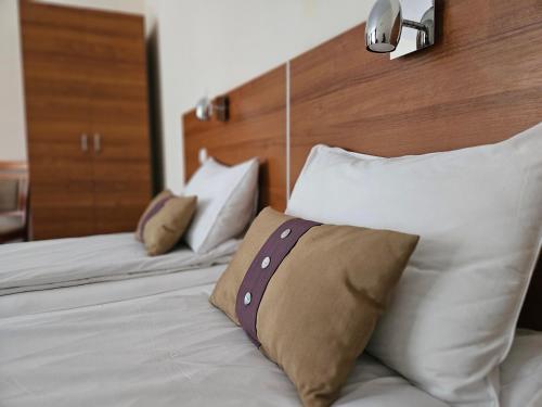 a bedroom with two beds with white pillows at Hotel Saint Nedelya in Kolarovo