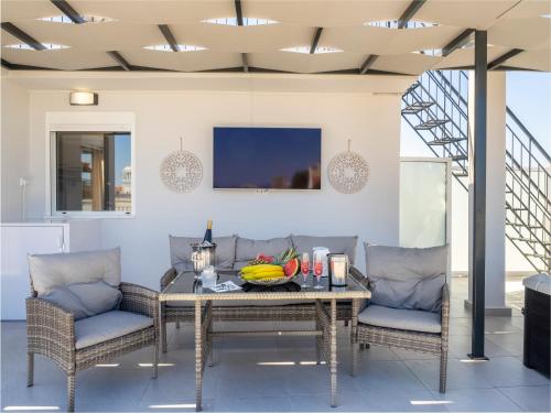 a dining room with a table and chairs at JACUZZI penthouse - King's view in Artemida