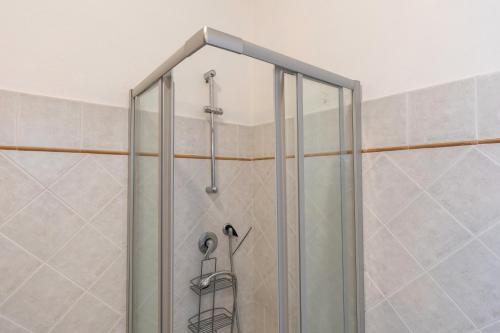 a shower with a glass door in a bathroom at La Sassetta in Bibbona