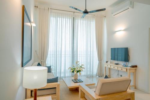 a living room with a couch and a table at Oceanfront Galle by ICC in Galle
