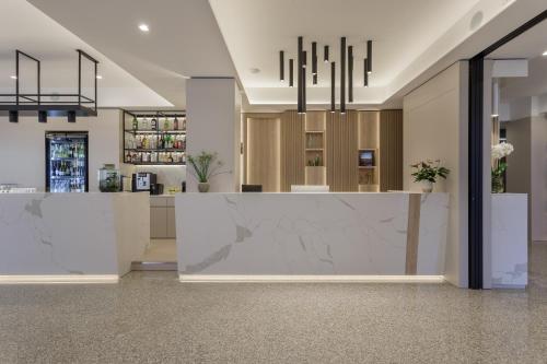a lobby with a reception counter and a bar at Hotel Riviera in Riva del Garda