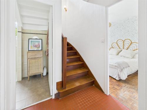 a hallway with a staircase leading to a bedroom at -SUZANNE- Maison de charme au coeur de Nevez in Névez