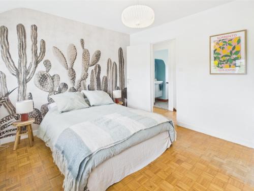 a bedroom with a bed with a cactus wall at -SUZANNE- Maison de charme au coeur de Nevez in Névez