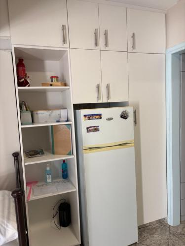 a refrigerator in a kitchen with white cabinets at MEIMETIS GREEN HOUSE in Neapolis