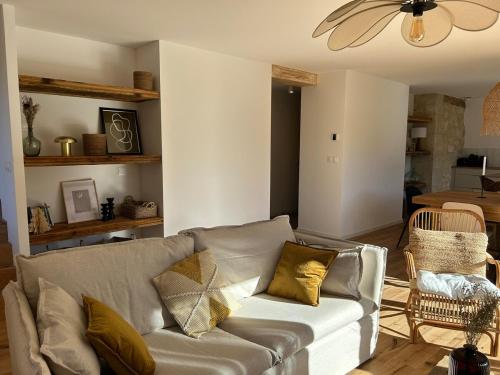 a living room with a couch and a table at Gite d'exception en pleine nature in Prémanon